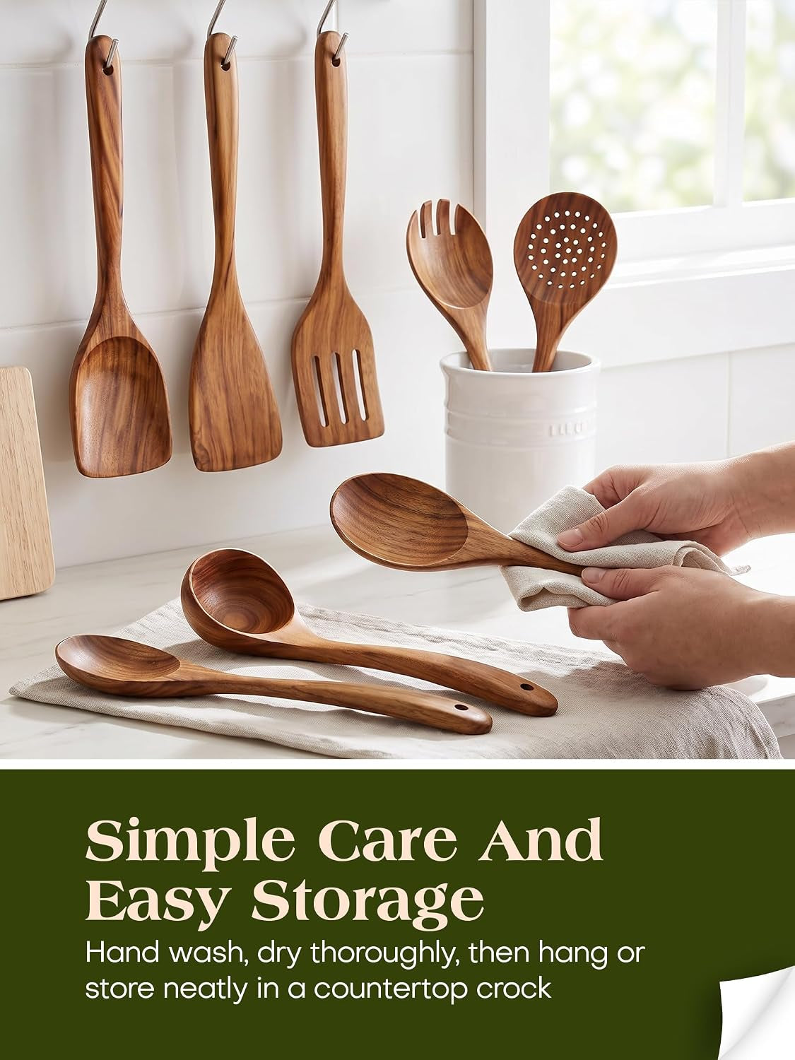 Teak utensils hanging on hooks and being dried with a cloth
