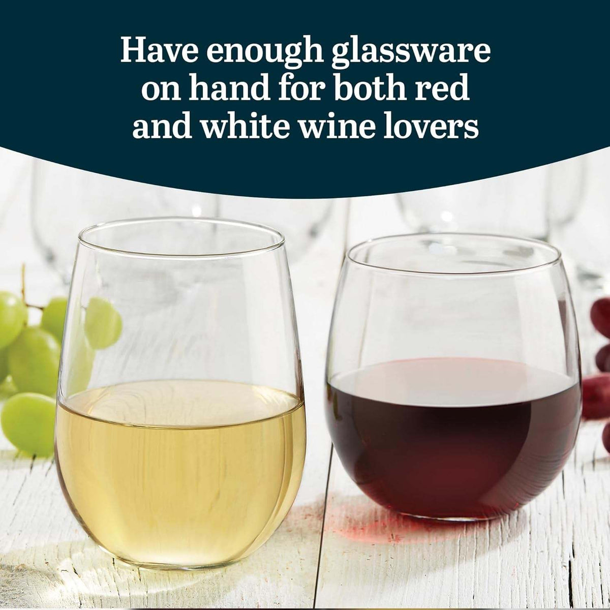 Stemless glasses with white and red wine on a table with grapes