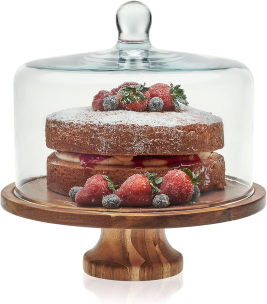 Libbey acacia wood cake stand with glass dome holding a layer cake with berries
