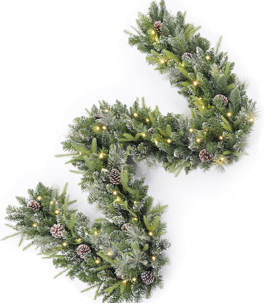 Snow-tipped Christmas garland with pine cones and warm white lights