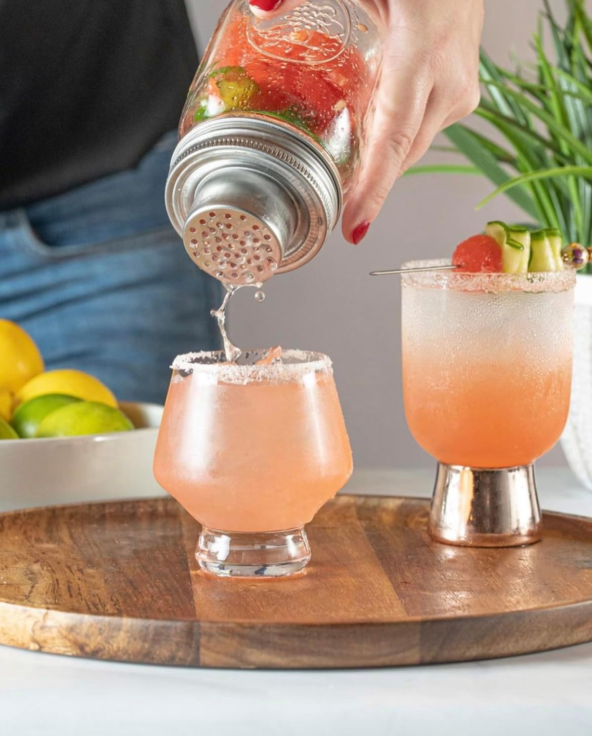 Cocktail poured from a shaker into Viski Raye punch cups