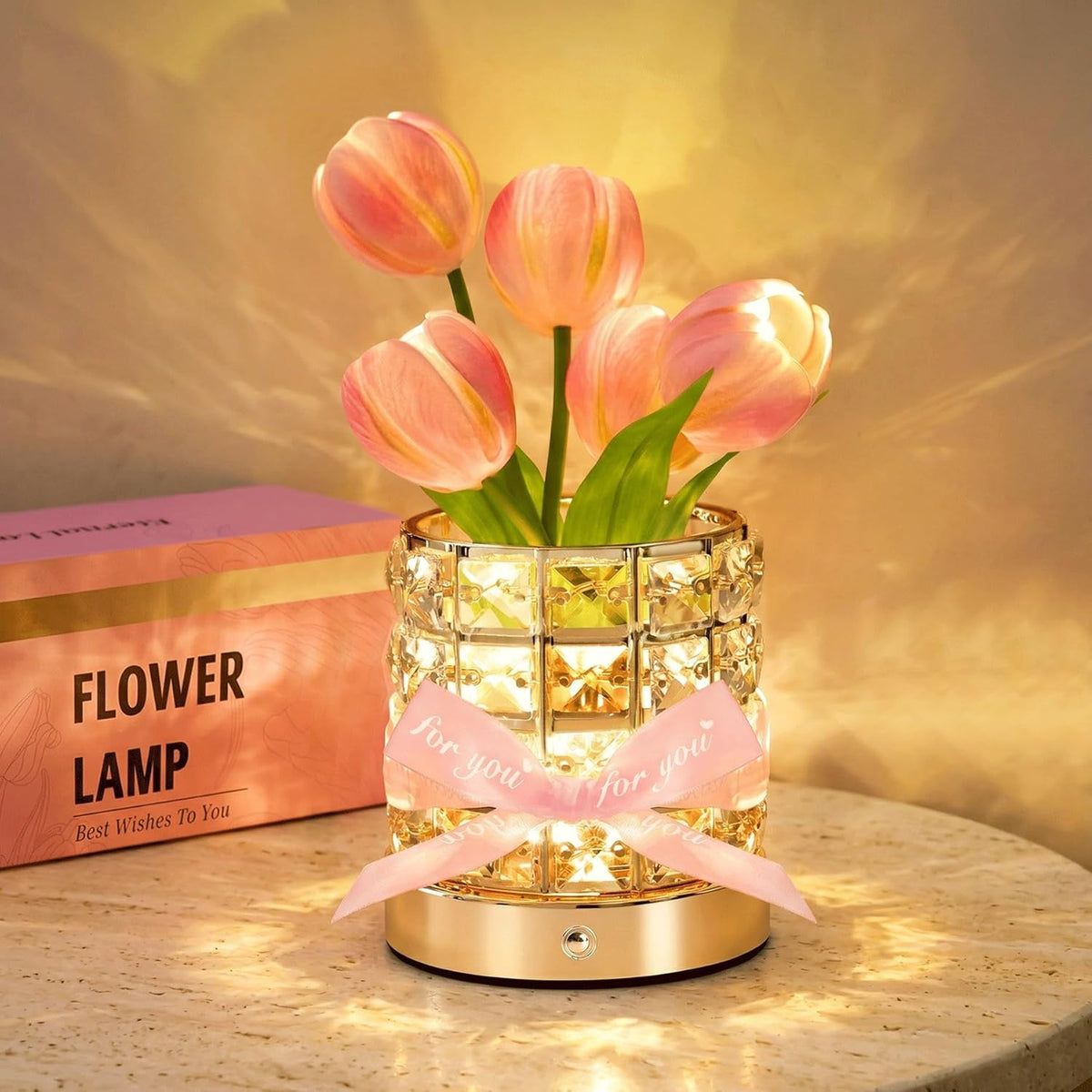 Pink tulip table lamp glowing in a crystal-style holder with a gold-tone base