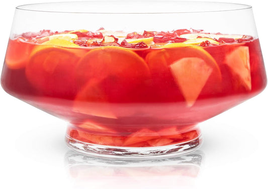 Viski footed glass punch bowl filled with red punch, orange slices and ice
