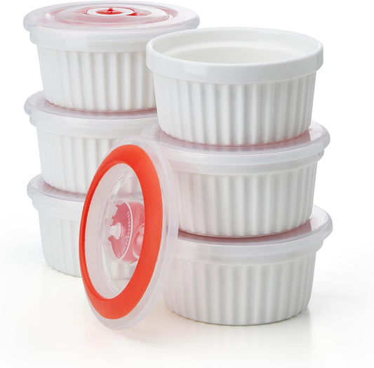Six white porcelain ramekins with lids, stacked