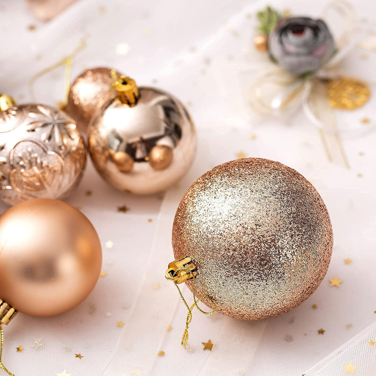 Shiny, matte and glitter champagne ornaments on a table