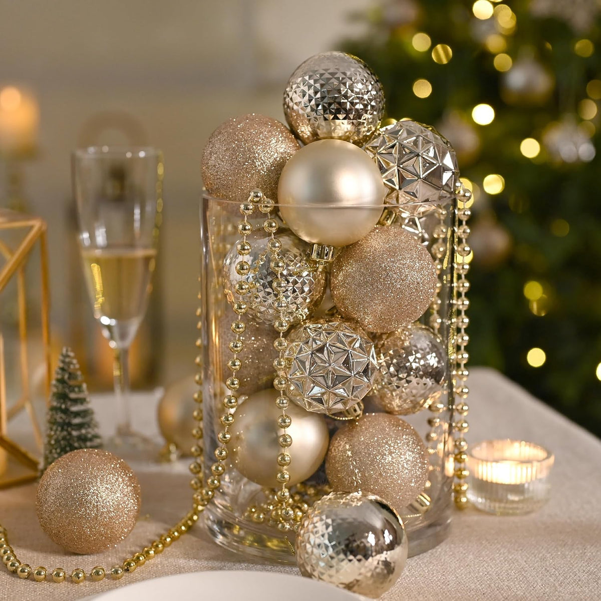 Champagne ornaments in a glass vase as a table centerpiece