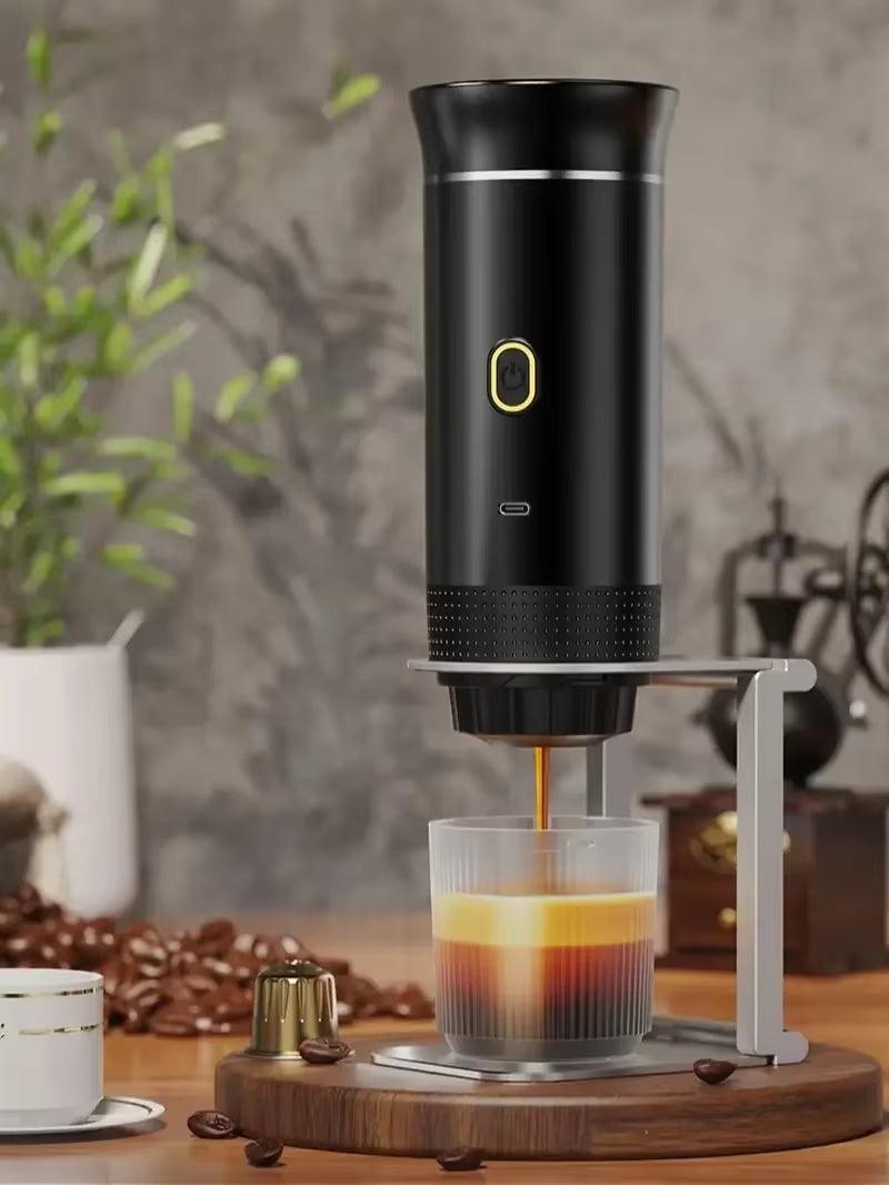 Black portable espresso maker brewing into a glass cup