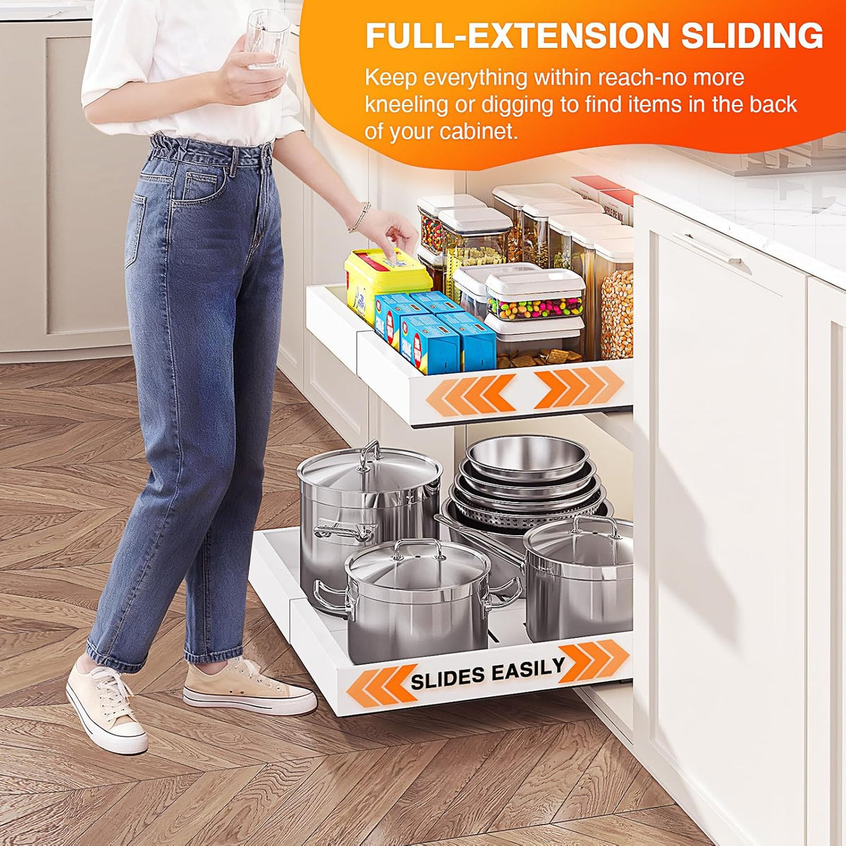 Person sliding out two pull-out organizers in a kitchen cabinet
