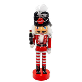 Kurt Adler 10-inch Coca-Cola nutcracker, front view: red jacket, red and white striped pants, black fur hat and a Coca-Cola bottle in hand