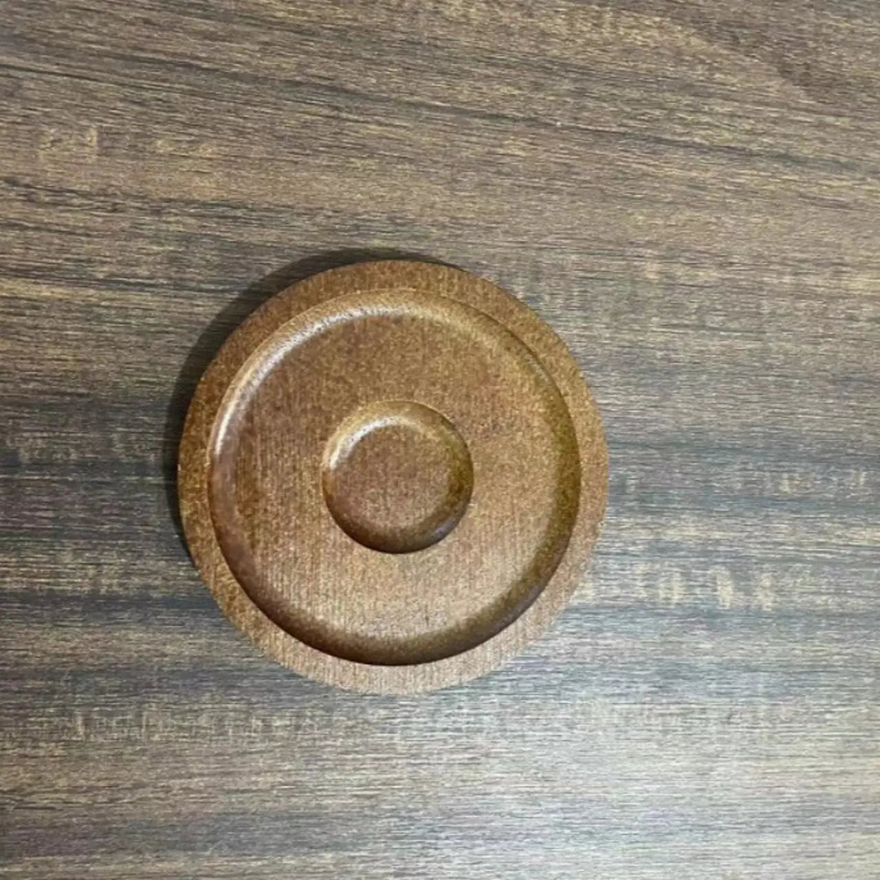 Close-up view of the weighted rotating base on the bottom of the whiskey tumbler