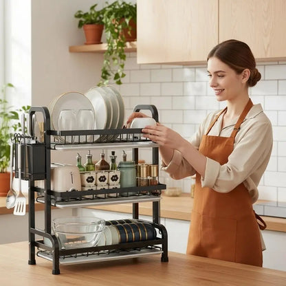 Woman placing dishes on 3-tier stainless steel dish drying rack in modern kitchen